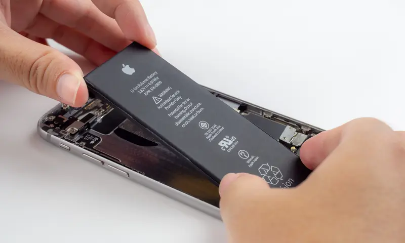 Someone replacing the battery on an iPhone
