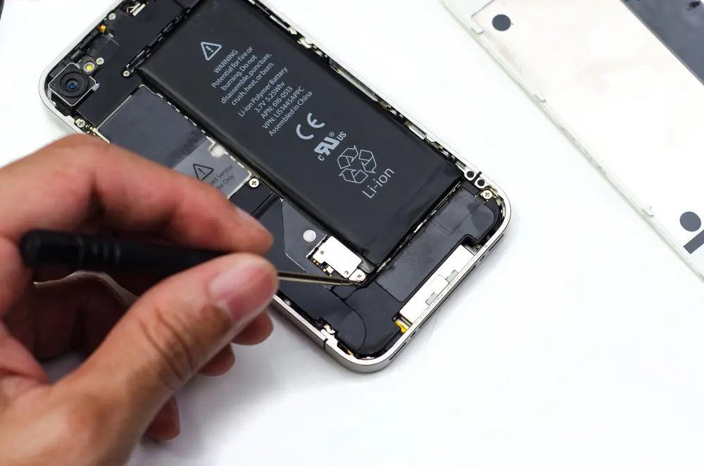 Someone doing an iPhone battery replacement.